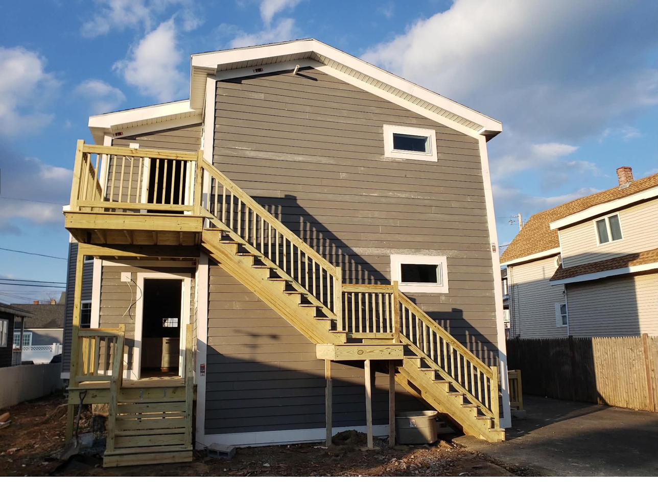 Multi-story residential home with custom deck and staircase